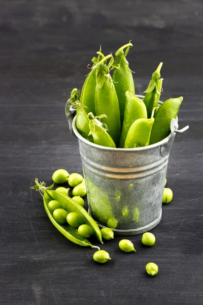Fresh green peas in small bucket