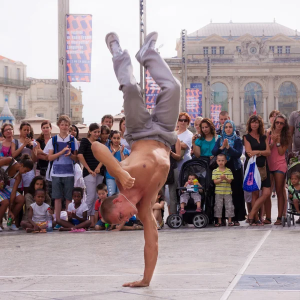Street performer breakdancing on street.