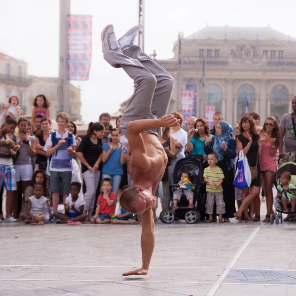 Street performer breakdancing on street.
