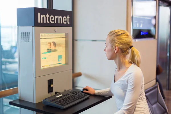 Woman public internet access point on airport.