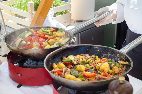 Cheff cooking on outdoor street food festival.