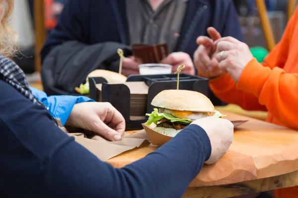 Beef burgers being served on street food stall