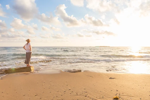 Free Happy Woman Enjoying Sunset on Sandy Beach