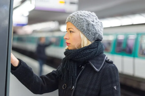 Lady buying ticket for public transport.