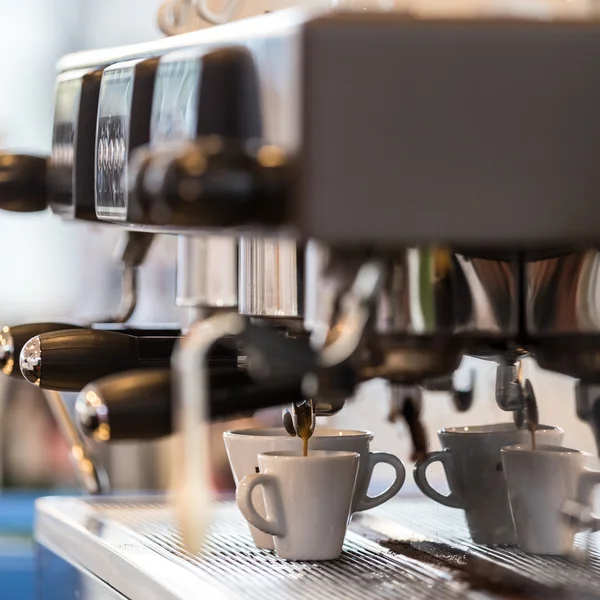 Professional coffee machine making espresso.