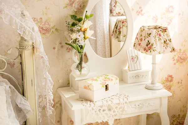 Table with mirror and flowers in provence style