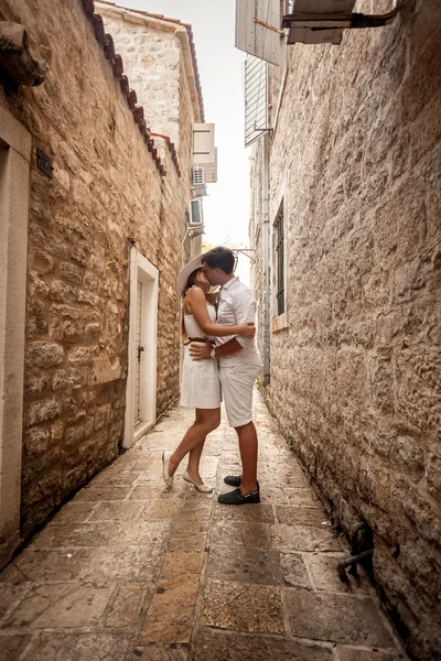 Young couple in love kissing on old narrow street