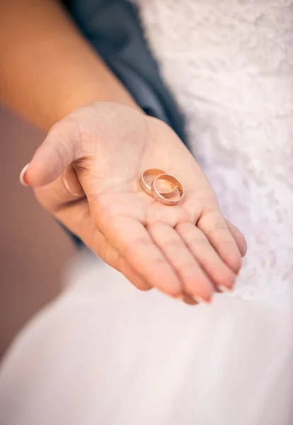 Beautiful bride holding wedding ring on hand