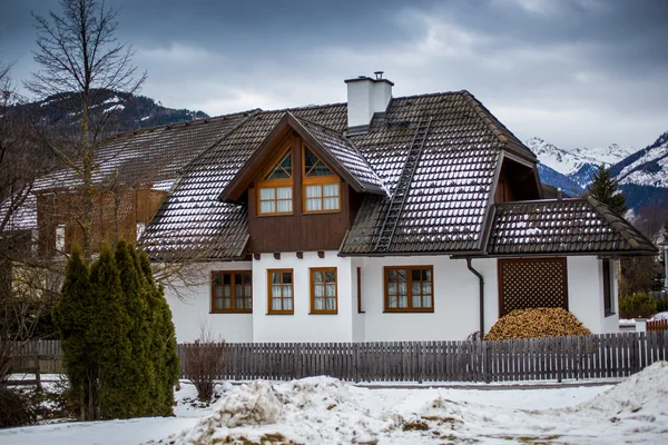 Wooden house in Austrian Alps at snowy day