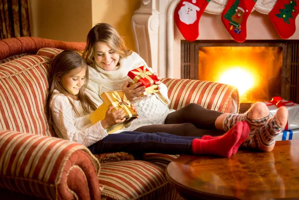 Mother and daughter looking inside of Christmas gift box