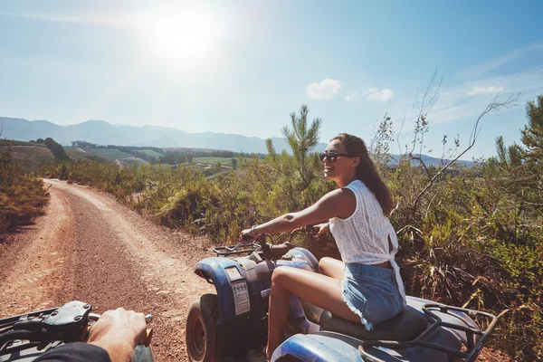 Young woman driving all terrain vehicle in nature