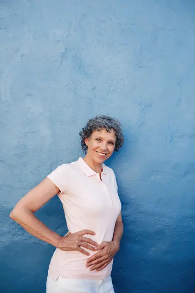 Confident mature woman posing to camera