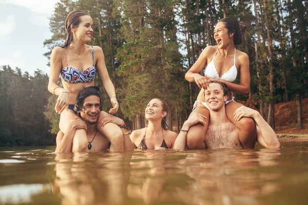 Young friends having fun in a lake