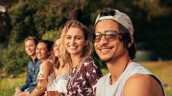 Group of young friends sitting outdoors