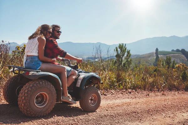 Couple in nature on a quad bike