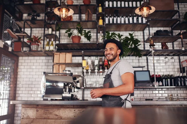 Happy bar owner standing at the counter