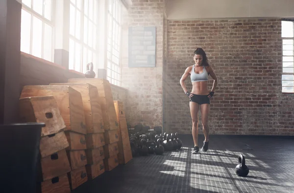 Fit young woman walking in the crossfit gym