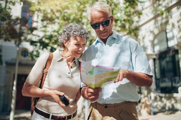 Middle aged couple looking at a map