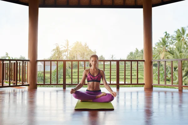 Woman meditating in lotus yoga pose