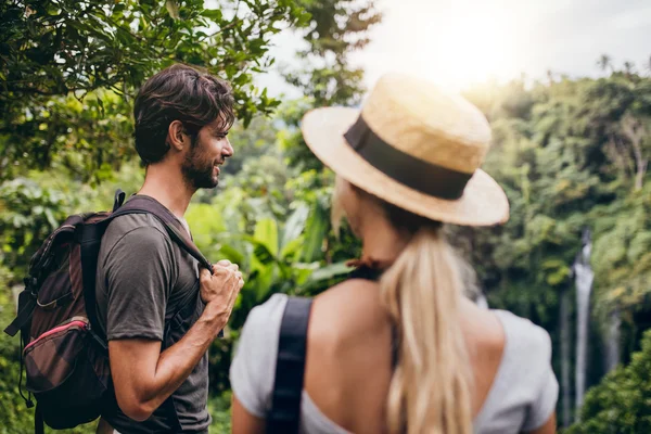 Man standing with his girlfriend in forest