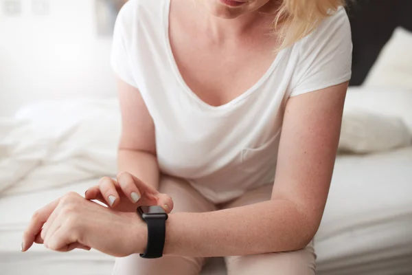 Female checking time on her wrist watch