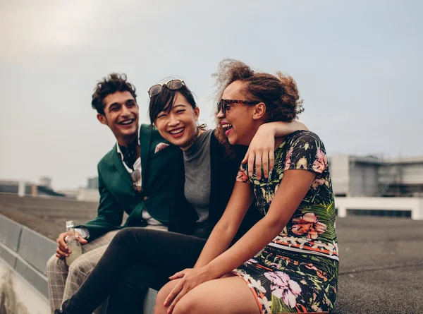 Friends laughing together on rooftop