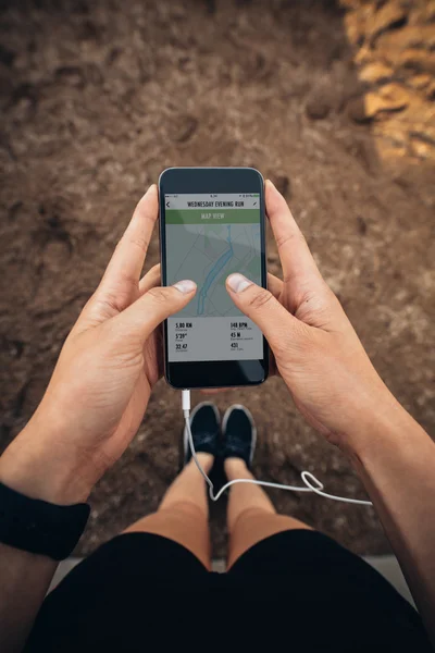 Runner using a fitness app on her mobile phone