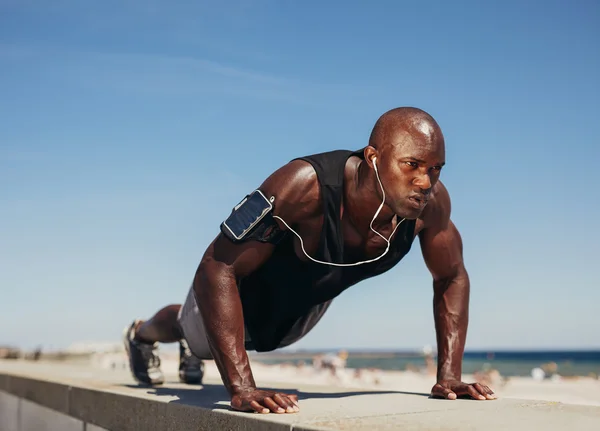 Young athletic man doing push-ups