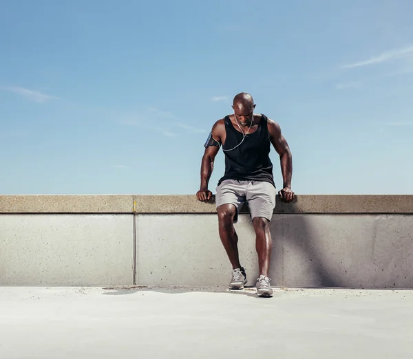 Young man taking breath after his run