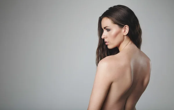 Naked female model on grey background