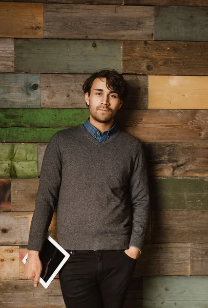 Handsome young executive standing relaxed in office