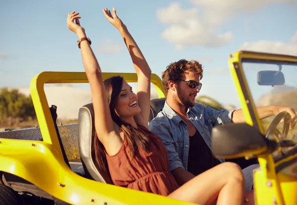 Cheerful young couple enjoying road trip