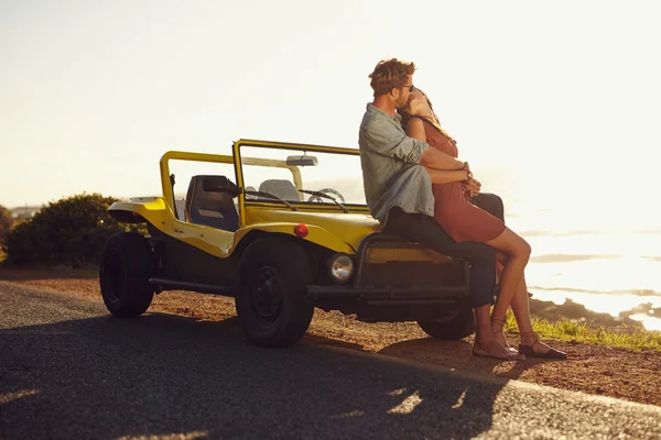 Couple on road trip sharing a romantic kissing