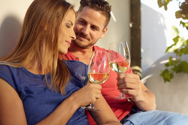 Young couple celebrating with white wine together