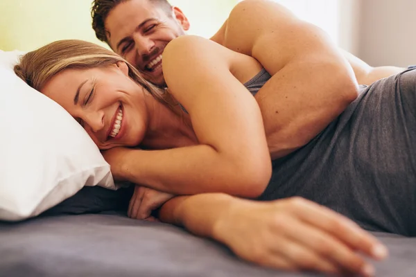 Cute young couple in love lying on bed