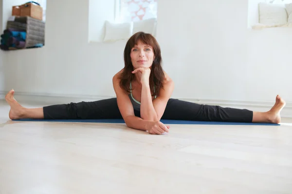 Woman doing wide angle seated forward bend yoga