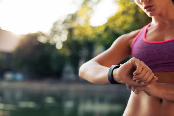 Woman setting up the smartwatch for running