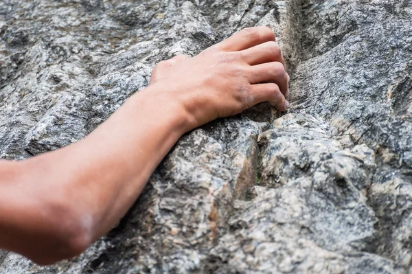 Climber\'s Hand Holding a Rock