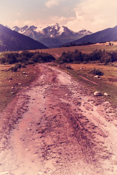 Vintage road in valley after rain
