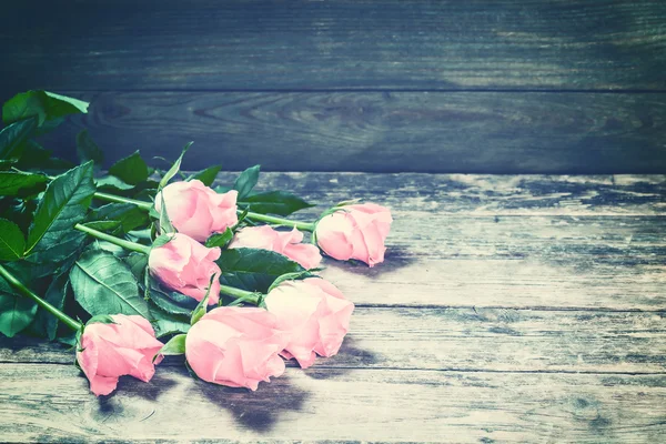 Vintage Rose Flowers on Rustic Backdrop