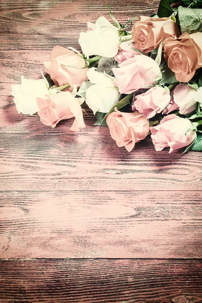 Vintage Rose Flowers on Rustic Backdrop