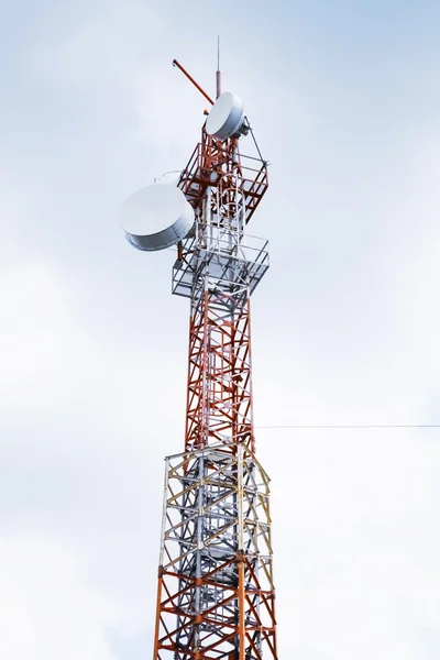 Telecommunication radio tower over cloudy sky