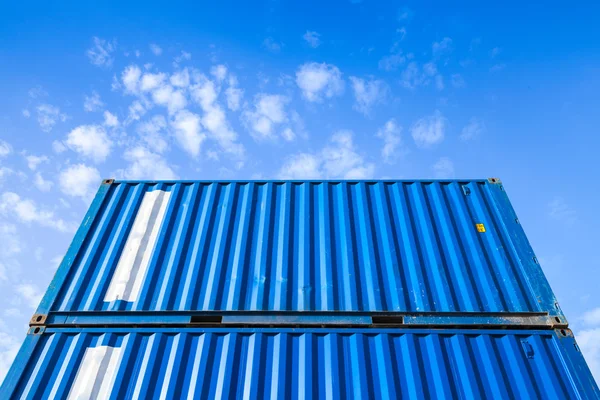 Blue steel Industrial cargo containers under cloudy sky