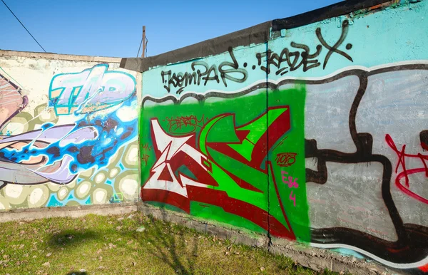Corner with colorful graffiti, chaotic patterns and text