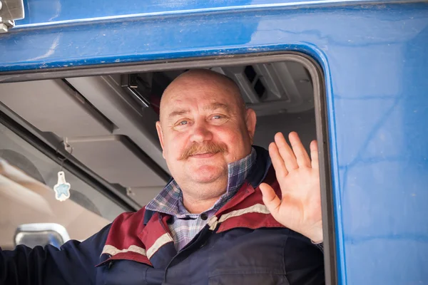 Senior mustached truck driver smiles