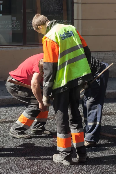 Men at work, urban road under construction