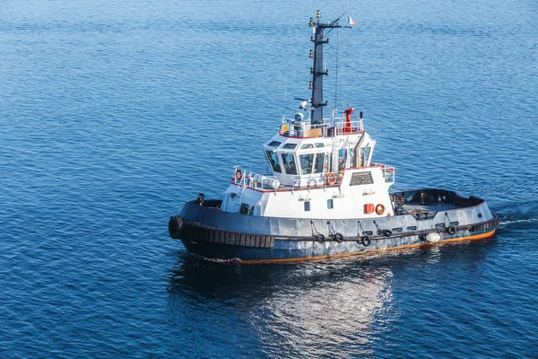 Small tug boat with white superstructure