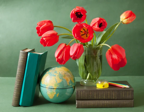 World Teacher\'s Day (still life with tulips bunch, book pile, globe and pencil)