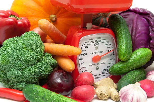 Ripe fresh vegetables and kitchen scale closeup