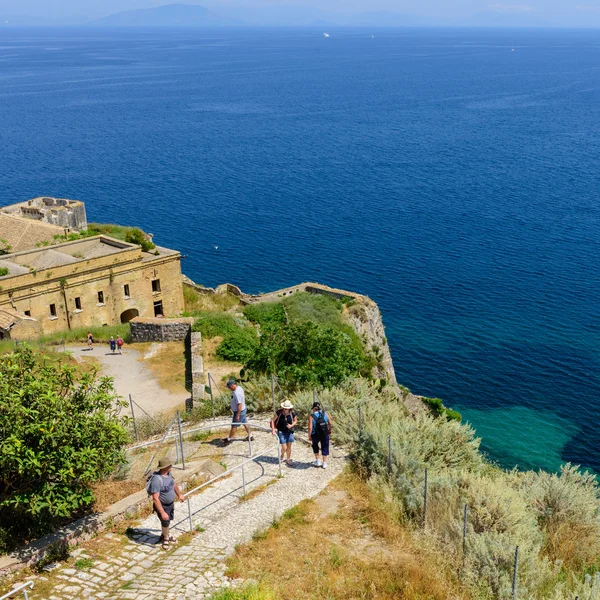 Corfu, Greece - tourists walking up to the lighthouse at Old Fortress.